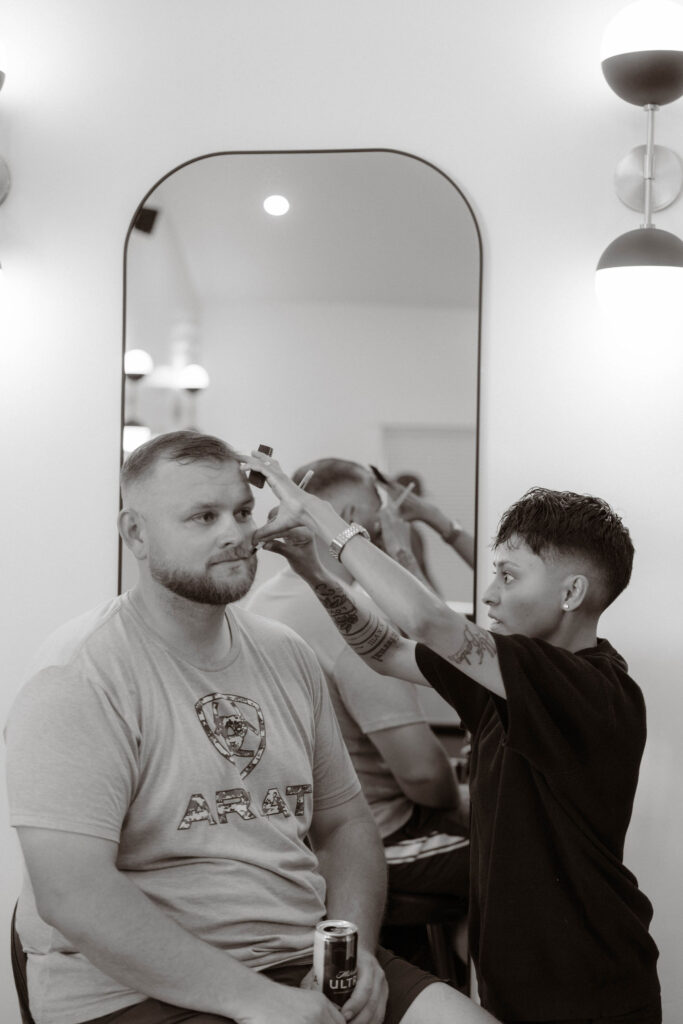 Groom Conner receiving a precise haircut from Al the Barber before his wedding ceremony at White Barn Weddings in Emmett, Idaho