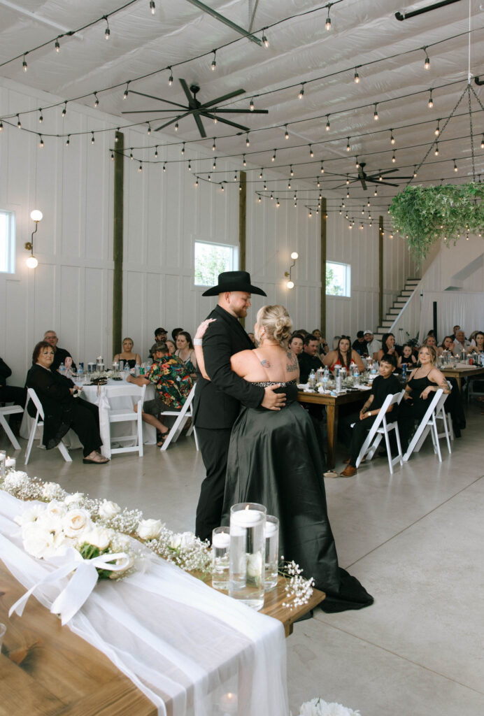 Groom Conner dancing with his mother during the reception at White Barn Weddings in Emmett Idaho, surrounded by friends and family